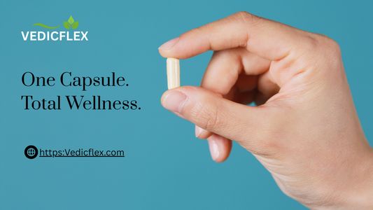 Hand holding a single capsule against a blue background with the VedicFlex logo and the text "One Capsule. Total Wellness.