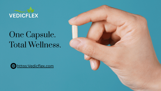 Hand holding a single shilajit capsule Total Wellness.